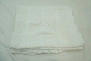 white knitted throw blanket with ribbed border