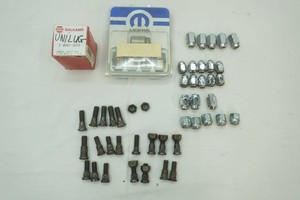 assortment of vintage wheel studs and nuts in a variety of styles and sizes