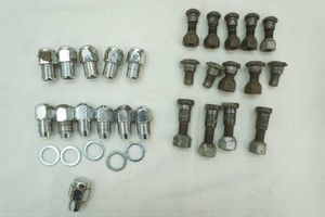 assortment of vintage wheel studs and nuts in a variety of styles and sizes