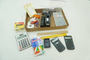 home office supplies including calculators, tape dispenser, stapler, rulers and more