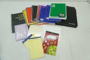 group of new and lightly used note books, binder, stationary, small legal pads