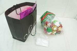 bag full of gift bags, ribbon, and bows