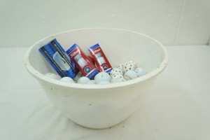 large bowl full of golf balls and whiffle balls