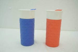 2 Ello Ogden Ceramic Travel Mugs white ceramic body with textured silicone sleeve and matching friction fit lids