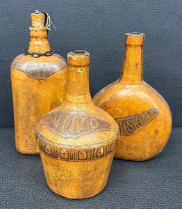 Trio of Vintage Hand Tooled Leather Wrapped Decanter Bottles