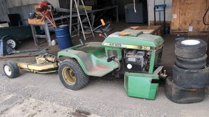John Deere 318 Lawn and Garden Tractor with an aircraft handling attachment.