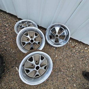 Set of Olds Rally Rims and 1 Pontiac Chrome