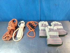 Extension cord, a white power strip, another cord with a plug, and three pairs of work gloves.