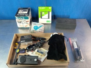 Collection of assorted items, including a coin sorter kit, a green Western Digital storage box, tools, and a tire repair kit.