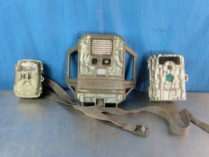 3 outdoor trail or game cameras with camouflage patterns