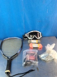 Racquetball gear, including a strung racquet, protective goggles, wrapped balls or accessories, and a packaged grip or string.