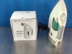 Clothes iron on the right and a new portable garment steamer on the left.