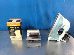 80-hour Candle by the Hour Refill, a small stack of media cases, and a Proctor Silex Nonstick Steam Iron