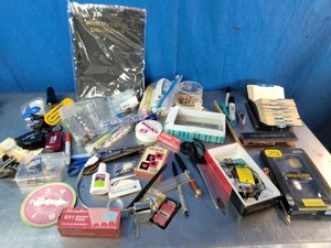 Collection of various small office supplies, tools, and miscellaneous
