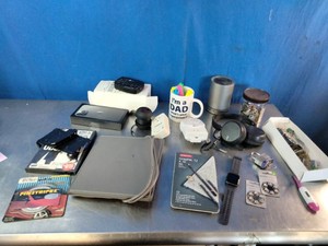 Miscellaneous collection of items, including electronics, a coffee mug