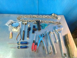 Assortment of hand tools, security chains, and hardware items