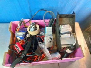 Assortment of used automotive and electrical tools, including cords, a testing device, and miscellaneous gear.
