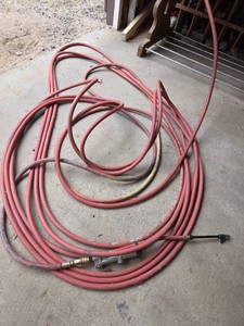 Air hose with attached tire inflator gauge
