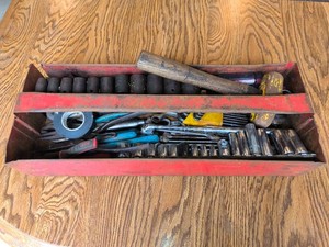 Red toolbox with assorted hand tools