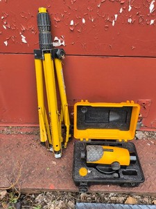 Self leveling rotary laser level with tripod