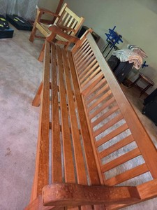 Very large slatted wooden bench with arms and matching chair with arms