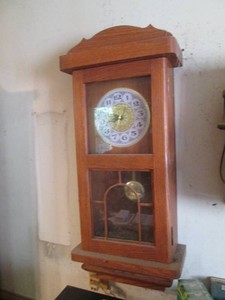 Wood Encased wall hanging pendulum clock