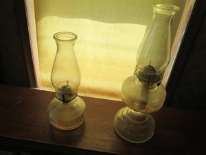 (2) assorted size antique glass oil lamps with hurricane shades