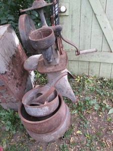 Antique metal cream separator with pots and parts shown