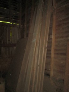 Bundle of barnwood planks and wood dowels with lengths reaching 14ft