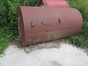 250-gallon metal gas tank we have a Bob cat to aid loading