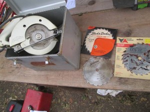 Sunbeam circular saw in metal case with assorted replacement saw blades
