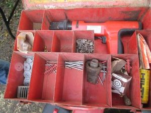 Hilti DX200 fastener with compartmentalized case and assorted fastener hardware