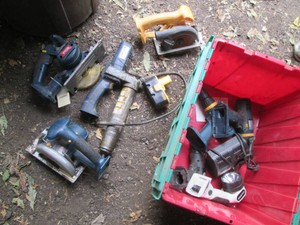 Clamshell closing tote full of assorted cordless power tools, Ryobi nica charger and single Dewalt 18v battery all untested