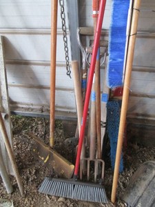 Fruit picker, shop brooms, pitch forks and shovel