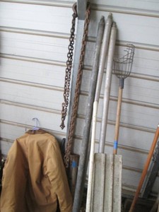 Landscape or masonry leveler with extension handles, fruit picker, post pounder and misc chains