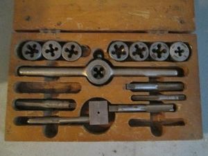 Tap and die set in vintage wood vase