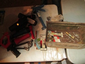 Metal ammo box with various flashlights, assorted hardware and supplies