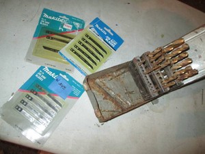 Drill bits in metal index case plus misc jig saw blades