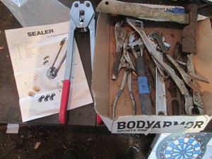 Plastic wrapping strapped, crescent wrenches, hatchet, vice grips and tin snip