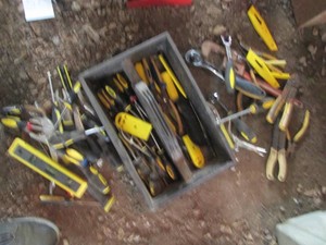 Deep tool tray full of screwdrivers, ratchets, wire strippers, pliers, vice grips, utility knives, hammers and other hand tools