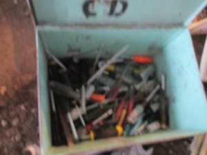 Metal toolbox containing assorted screwdrivers, wrenches, pliers and more