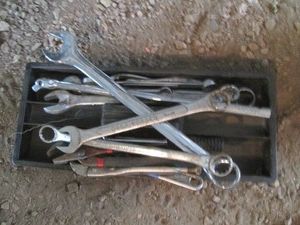 Tool tray containing larger size combination wrenches, breaker bar, pliers and more
