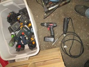 Tote with various electric and cordless power tools, chargers and batteries
