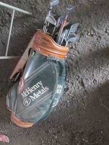 Vintage McHenry Metals golf bag with assorted clubs and drivers