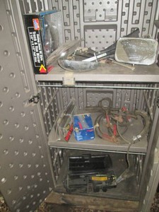Content of shop cabinet to include jumper cables, scissor jack with case and misc automotive accessories (cabinet NOT included)