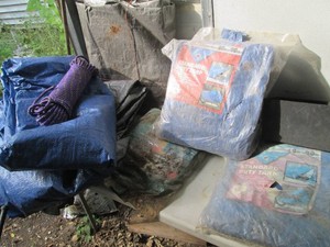 Collection of new and pre-owned tarps in assorted sizes plus unknown length rope