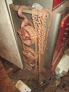 Vintage metal pulley hoist with chain