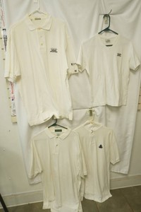 4 white polos size L and XL IZOD, Columbia, Cutter and Buck, Outer Banks these have a small stain on them