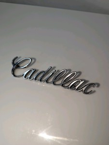 1970s-80s Cadillac script emblem, serial number on back