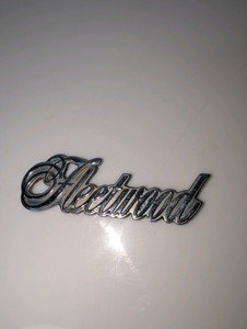 Cadillac Fleetwood script emblem, serial number on back